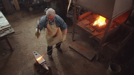 Blacksmith-Hammering-Heated-Iron-on-Anvil-in-Forge